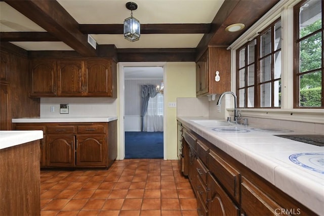 4312 Noble Ave, Sherman Oaks, CA 91403 - kitchen featuring beamed ceiling, light tile patterned floors, light carpet, and pendant lighting