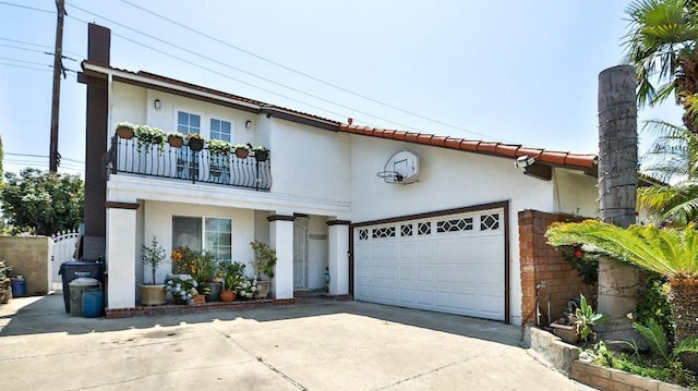 17230 San Lorenzo Cir, Fountain Valley, CA 92708 - mediterranean / spanish house with concrete driveway, stucco siding, an attached garage, and a balcony
