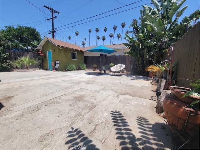 4434 Crocker St, Los Angeles, CA 90011 - fenced backyard featuring a patio area and an outbuilding