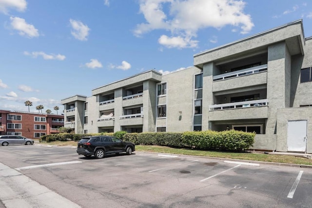 1040 E Washington Ave Unit 31, Escondido, CA 92025 - view of apartment building / complex featuring uncovered parking
