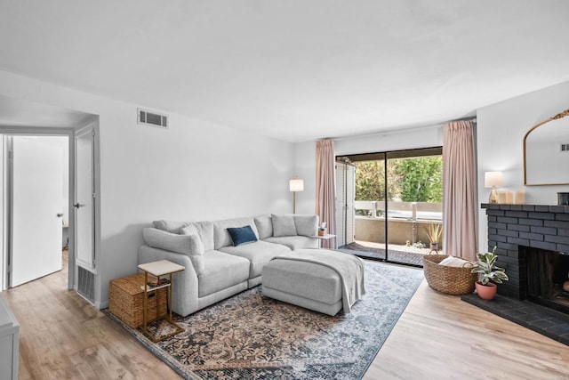 1040 E Washington Ave Unit 31, Escondido, CA 92025 - living area featuring wood finished floors and a brick fireplace