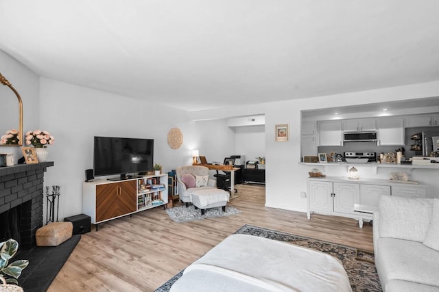 1040 E Washington Ave Unit 31, Escondido, CA 92025 - living area featuring light wood-style flooring and a fireplace