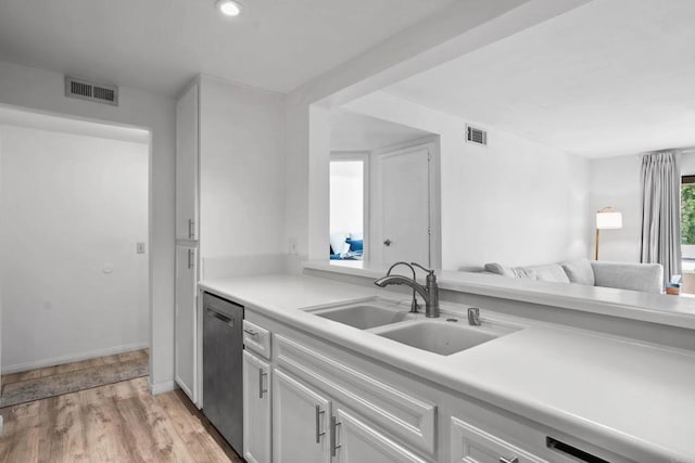 1040 E Washington Ave Unit 31, Escondido, CA 92025 - kitchen featuring stainless steel dishwasher, light countertops, light wood-style flooring, white cabinetry, and recessed lighting