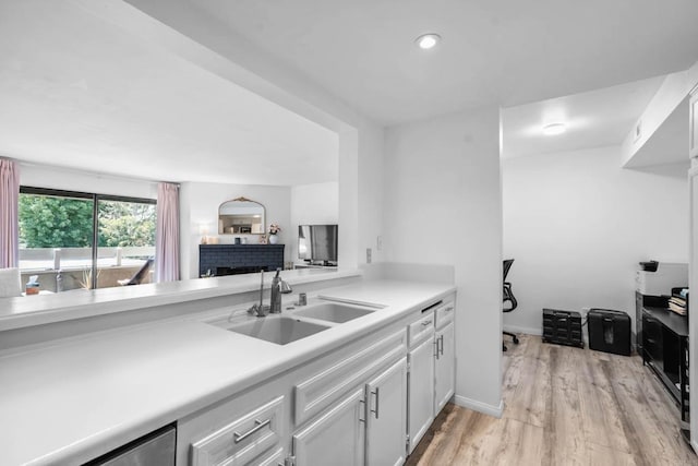 1040 E Washington Ave Unit 31, Escondido, CA 92025 - kitchen with light wood-style flooring, light countertops, white cabinets, and dishwasher