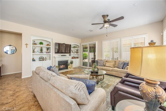 1506 Pierce Ml, Beaumont, CA 92223 - living room featuring ceiling fan, a fireplace with flush hearth, and built in shelves
