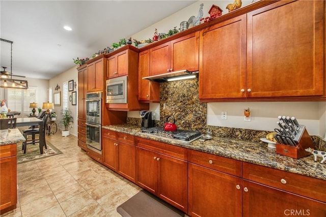 1506 Pierce Ml, Beaumont, CA 92223 - kitchen featuring appliances with stainless steel finishes, tasteful backsplash, dark stone countertops, under cabinet range hood, and recessed lighting