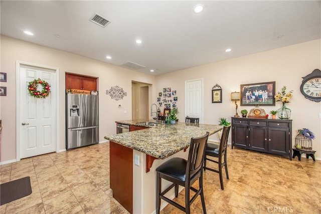 1506 Pierce Ml, Beaumont, CA 92223 - kitchen with stainless steel appliances, stone counters, a kitchen breakfast bar, recessed lighting, and a large island with sink