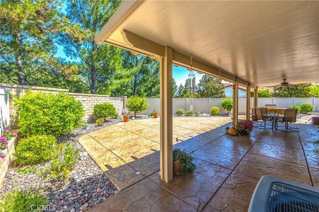 1506 Pierce Ml, Beaumont, CA 92223 - fenced backyard with a patio, outdoor dining space, and ceiling fan