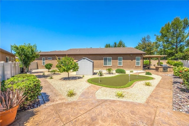 1506 Pierce Ml, Beaumont, CA 92223 - rear view of property with a putting area, stucco siding, a patio area, a fenced backyard, and a storage unit