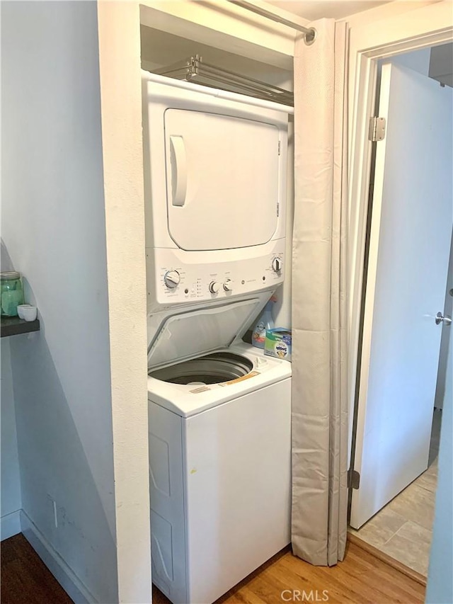 5800 Owensmouth Ave Unit 77, Woodland Hills, CA 91367 - washroom with stacked washer / dryer and light wood-style floors
