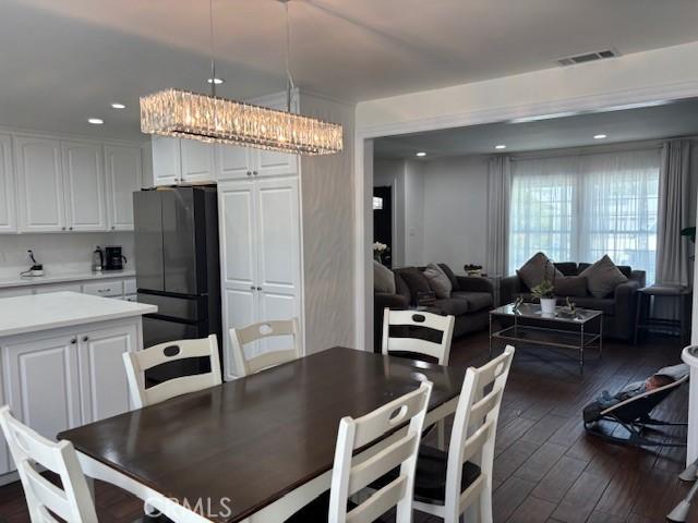 8596 Camelia Dr, Riverside, CA 92504 - dining area with dark wood finished floors, recessed lighting, and a chandelier