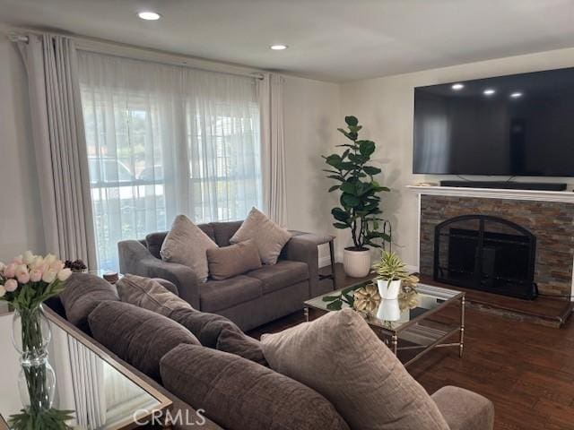 8596 Camelia Dr, Riverside, CA 92504 - living area with wood finished floors, a stone fireplace, and recessed lighting
