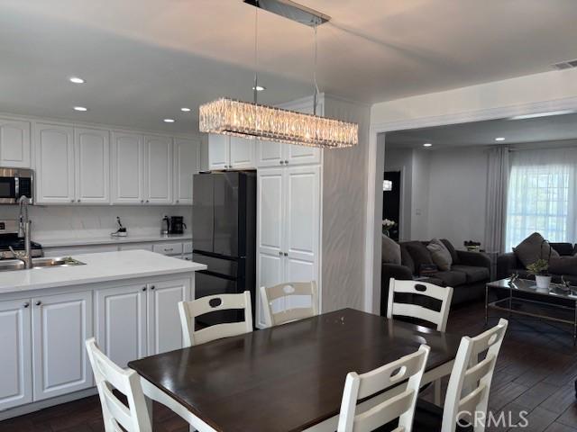 8596 Camelia Dr, Riverside, CA 92504 - dining room featuring dark wood-style floors and recessed lighting