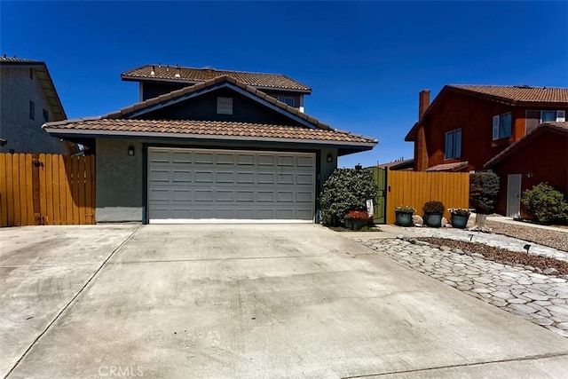 12164 Galaxy St, Victorville, CA 92392 - view of front of house featuring a tiled roof, concrete driveway, a garage, and stucco siding