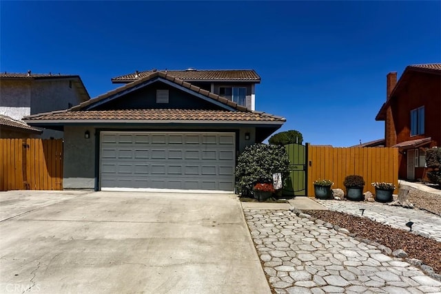 12164 Galaxy St, Victorville, CA 92392 - view of front of house with a tile roof, driveway, a garage, a gate, and stucco siding