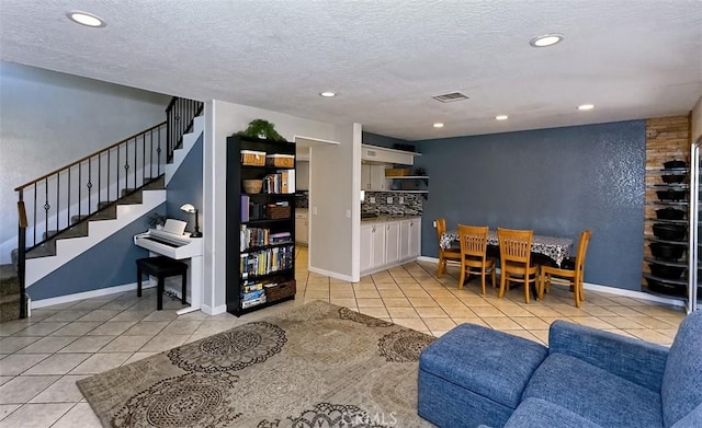 12164 Galaxy St, Victorville, CA 92392 - dining room with light tile patterned floors, stairway, recessed lighting, and a textured ceiling