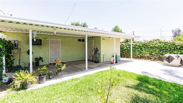 480 W D St, Colton, CA 92324 - rear view of property featuring stucco siding, a patio, electric panel, and a lawn