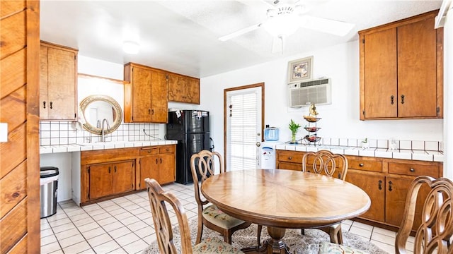 480 W D St, Colton, CA 92324 - kitchen featuring freestanding refrigerator, backsplash, tile countertops, and ceiling fan