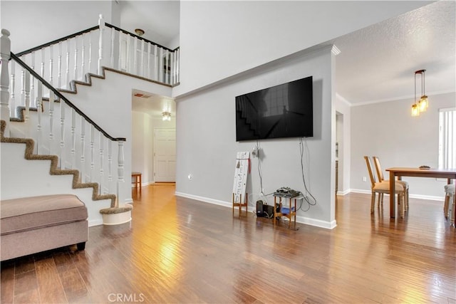 6701 Wrangler Rd, Chino Hills, CA 91709 - living area featuring wood finished floors, stairs, and ornamental molding