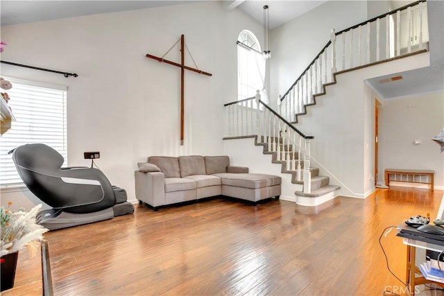 6701 Wrangler Rd, Chino Hills, CA 91709 - living room with wood-type flooring, plenty of natural light, high vaulted ceiling, and stairs