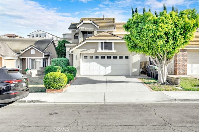 6701 Wrangler Rd, Chino Hills, CA 91709 - view of front of property featuring driveway, a tiled roof, stucco siding, and a garage