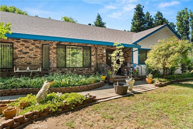 625 La Bonita Ct, Chico, CA 95973 - ranch-style house featuring brick siding, roof with shingles, a front lawn, and a patio area