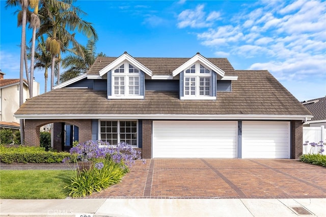 609 Calle Reata, San Clemente, CA 92673 - view of front of house featuring decorative driveway, brick siding, an attached garage, and a tile roof