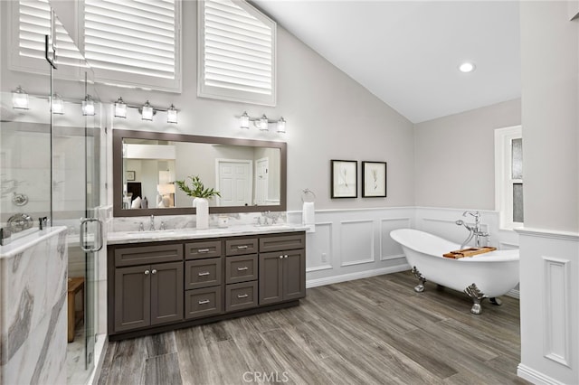 609 Calle Reata, San Clemente, CA 92673 - full bath featuring double vanity, a soaking tub, a shower stall, wood finished floors, and wainscoting