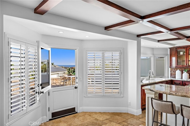 609 Calle Reata, San Clemente, CA 92673 - kitchen with beam ceiling, light stone countertops, glass insert cabinets, stone tile flooring, and recessed lighting