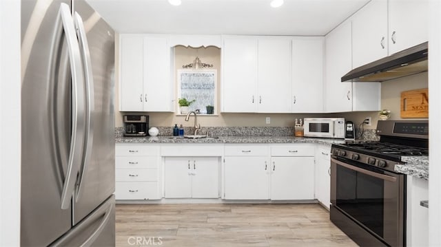 2648 N G St, San Bernardino, CA 92405 - kitchen featuring stainless steel appliances, under cabinet range hood, white cabinets, recessed lighting, and light stone counters