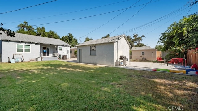 2648 N G St, San Bernardino, CA 92405 - rear view of house with stucco siding, a patio area, and an outdoor structure