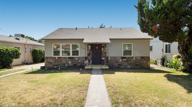 2648 N G St, San Bernardino, CA 92405 - bungalow featuring stone siding, a front yard, stucco siding, and a shingled roof