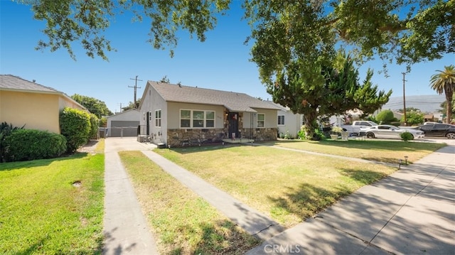 2648 N G St, San Bernardino, CA 92405 - view of front of house featuring stucco siding, stone siding, a front yard, and a garage