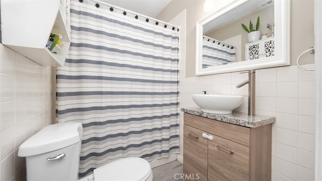 2648 N G St, San Bernardino, CA 92405 - full bathroom with tile walls and vanity