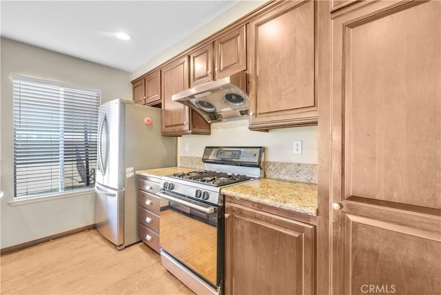 20530 Divonne Dr, Walnut, CA 91789 - kitchen featuring appliances with stainless steel finishes, under cabinet range hood, light wood-style floors, light stone counters, and brown cabinetry