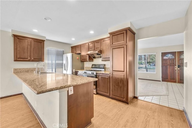 20530 Divonne Dr, Walnut, CA 91789 - kitchen featuring stainless steel range with gas cooktop, fridge with ice dispenser, a peninsula, under cabinet range hood, and light stone counters