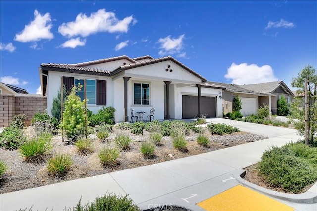 32469 Peters St, Menifee, CA 92584 - view of front of house featuring an attached garage, stucco siding, a tile roof, and driveway