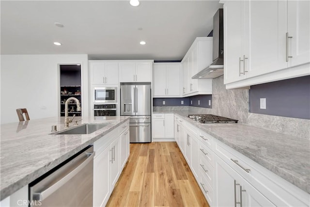 32469 Peters St, Menifee, CA 92584 - kitchen featuring appliances with stainless steel finishes, wall chimney exhaust hood, recessed lighting, white cabinets, and light wood-type flooring