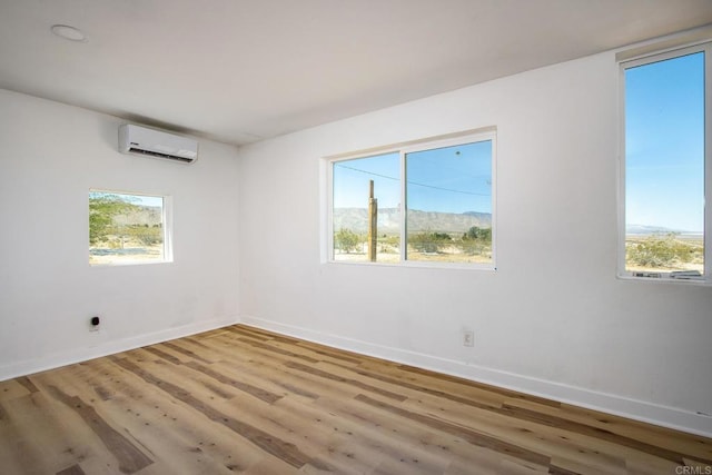 5655 Last Mile Rd, Johnson Valley, CA 92285 - unfurnished room with a wall unit AC and wood finished floors