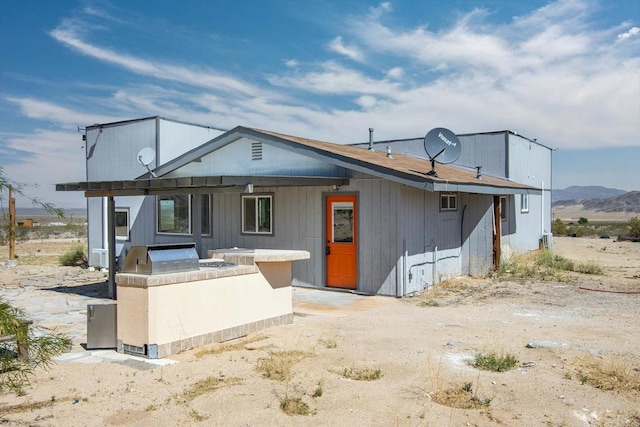 5655 Last Mile Rd, Johnson Valley, CA 92285 - view of front facade featuring an outdoor kitchen and a mountain view