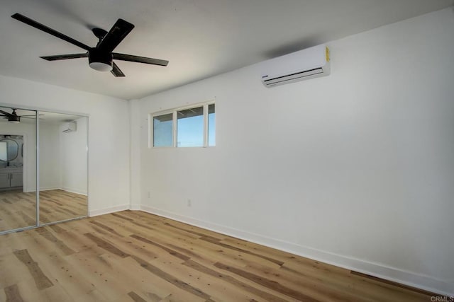 5655 Last Mile Rd, Johnson Valley, CA 92285 - unfurnished bedroom with a wall unit AC, light wood-style floors, a closet, and a wall mounted AC