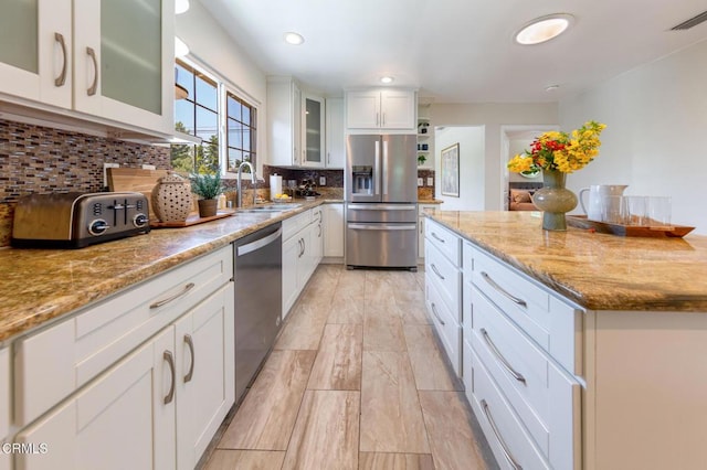 2767 Brookhill St, La Crescenta, CA 91214 - kitchen featuring stainless steel appliances, backsplash, white cabinets, light stone countertops, and recessed lighting