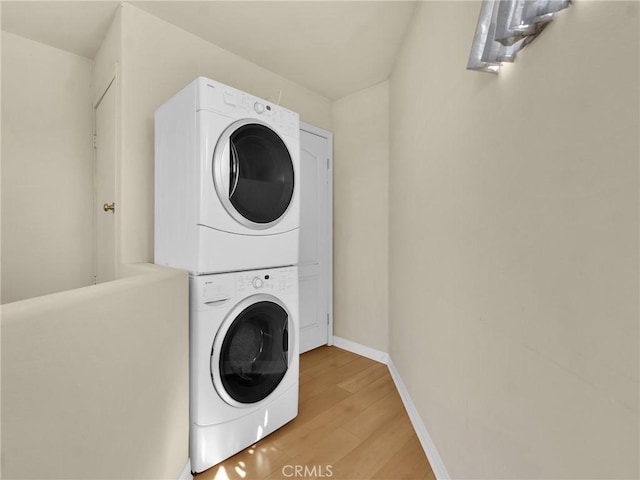 5242 Vesper Ave Unit 7, Sherman Oaks, CA 91411 - washroom featuring stacked washer / drying machine and light wood-type flooring