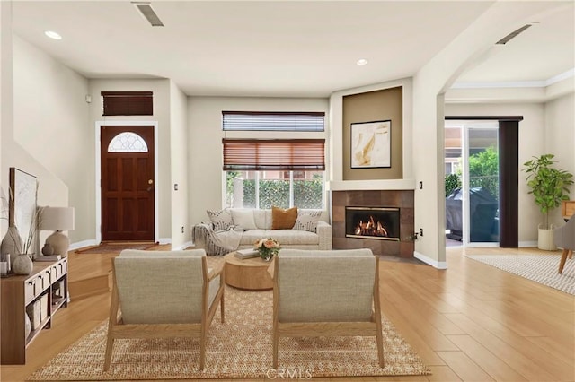 5242 Vesper Ave Unit 7, Sherman Oaks, CA 91411 - living area with a tiled fireplace, light wood-style flooring, recessed lighting, and arched walkways