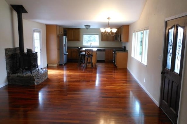 1020 Alpha St, Eureka, CA 95503 - kitchen with white appliances, a chandelier, a wood stove, and dark wood-style flooring