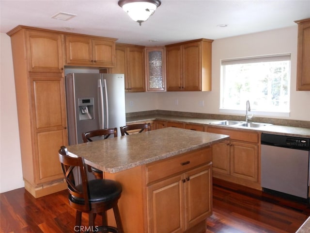 1020 Alpha St, Eureka, CA 95503 - kitchen with dishwashing machine, stainless steel fridge with ice dispenser, a breakfast bar area, and dark wood-style flooring