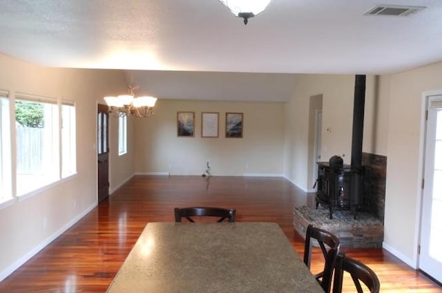 1020 Alpha St, Eureka, CA 95503 - dining space featuring wood finished floors, a chandelier, and a wood stove