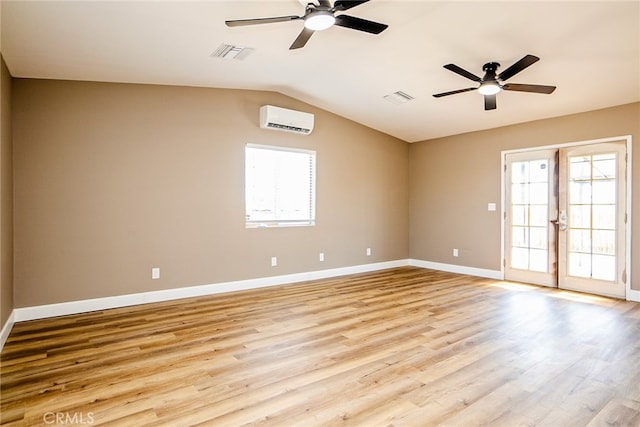 73570 Cedar Dr Unit 29, Palms, CA 92277 - spare room with ceiling fan, light wood finished floors, a wall unit AC, and lofted ceiling