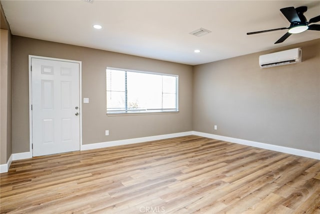 73570 Cedar Dr Unit 29, Palms, CA 92277 - empty room with an AC wall unit, light wood-style floors, and recessed lighting