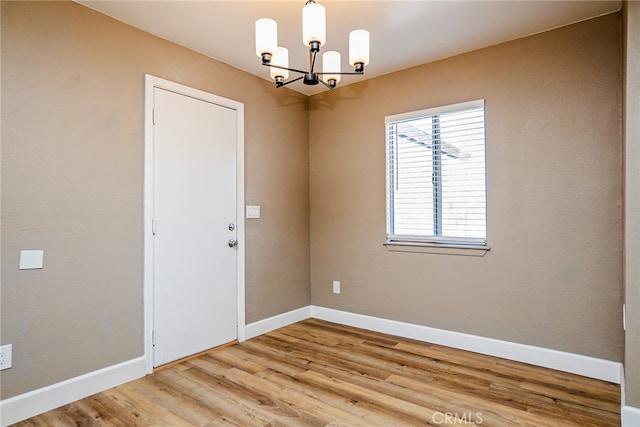 73570 Cedar Dr Unit 29, Palms, CA 92277 - unfurnished room with a chandelier and wood finished floors